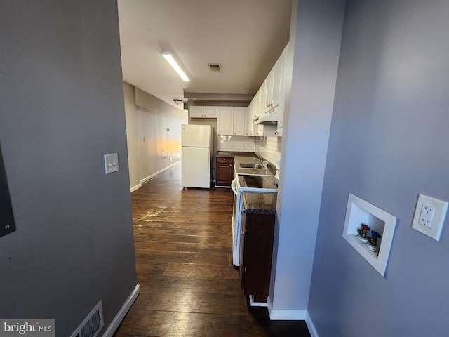 528 N Montford Ave, Baltimore, MD 21205 - hallway with a sink, dark wood-style flooring, visible vents, and baseboards