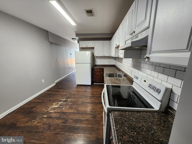 528 N Montford Ave, Baltimore, MD 21205 - kitchen featuring backsplash, visible vents, under cabinet range hood, white appliances, and dark countertops