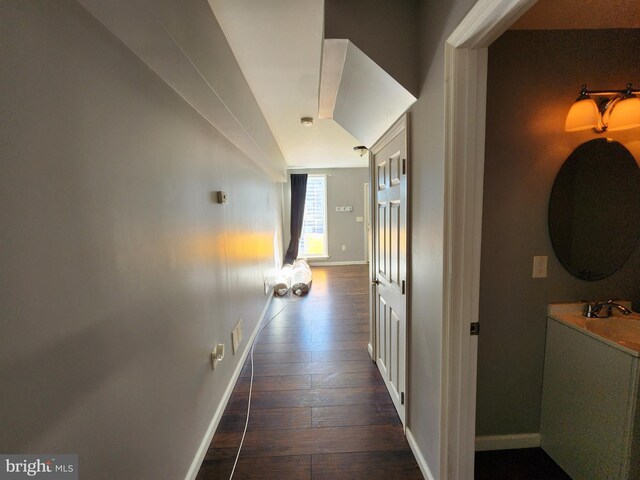 528 N Montford Ave, Baltimore, MD 21205 - hall with dark wood-style flooring, baseboards, and visible vents