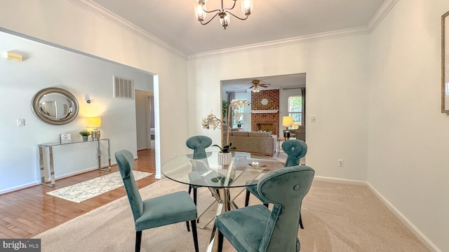 1009 Cadmus Dr, Fredericksburg, VA 22401 - dining space featuring ornamental molding, a chandelier, baseboards, and a fireplace