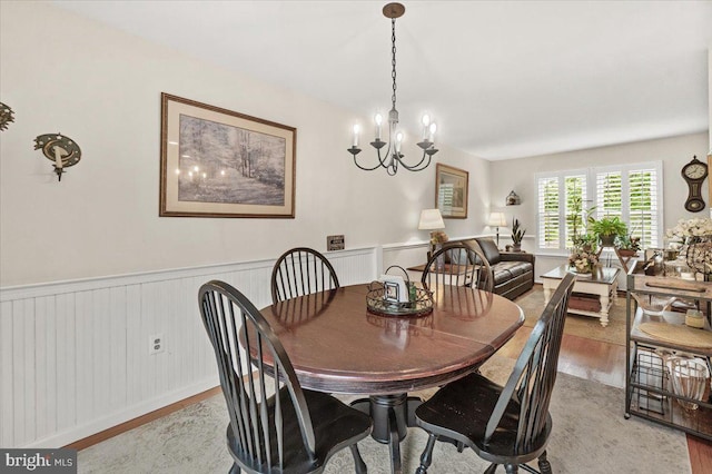 25112 Applecross Ter, Damascus, MD 20872 - dining space featuring wood finished floors, a chandelier, and a wainscoted wall