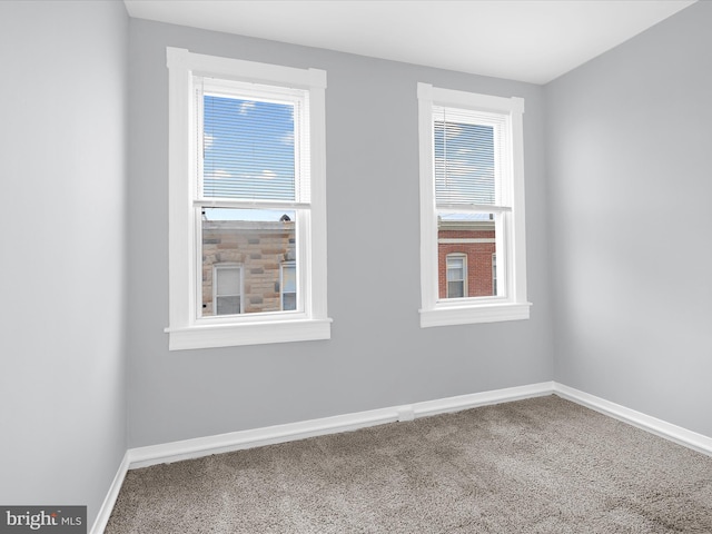 empty room with baseboards and carpet floors