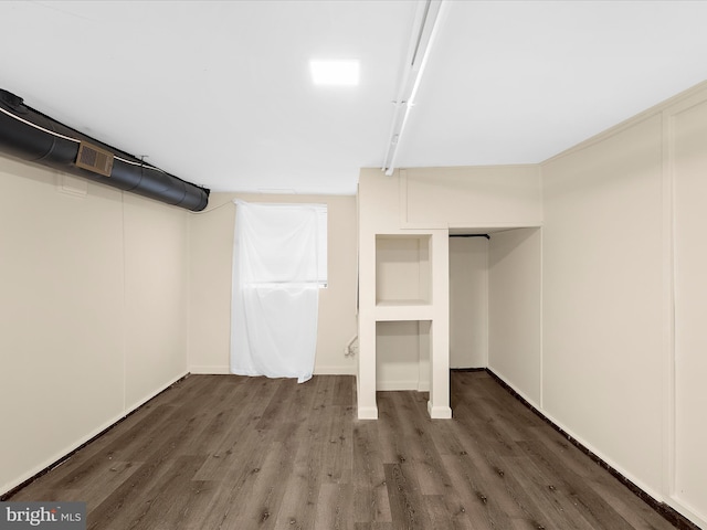 finished basement with visible vents and wood finished floors