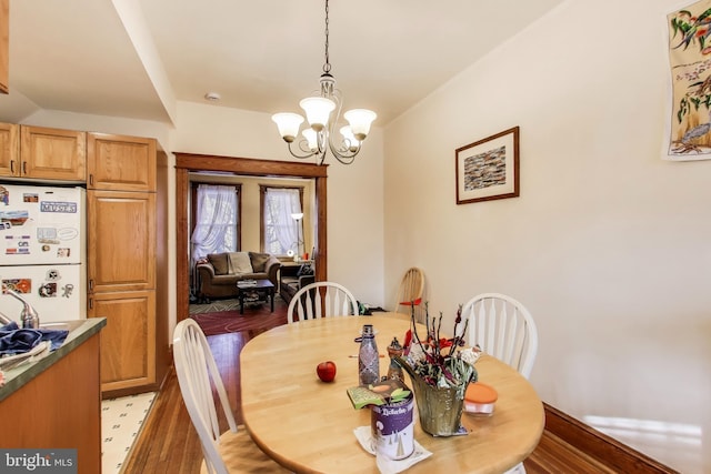dining space featuring an inviting chandelier and light wood-style floors