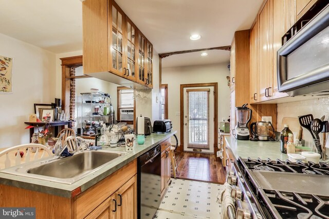 332 13th St SE, Washington, DC 20003 - kitchen featuring a sink, brown cabinetry, recessed lighting, glass insert cabinets, and black appliances
