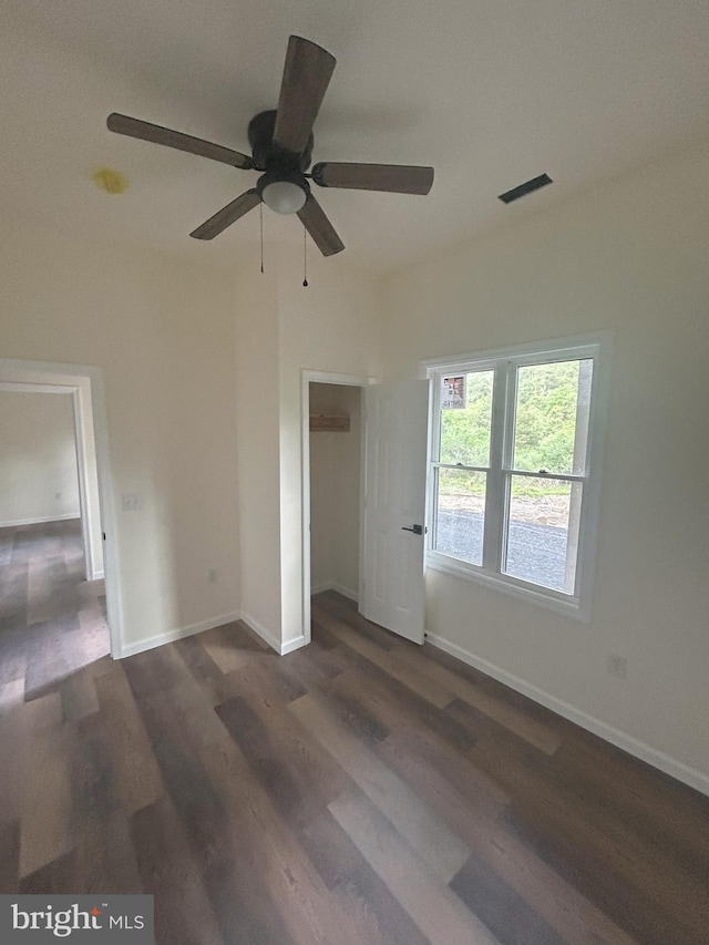 Meadow View Dr, Lost City, WV 26810 - unfurnished bedroom with dark wood finished floors, a closet, baseboards, and a ceiling fan