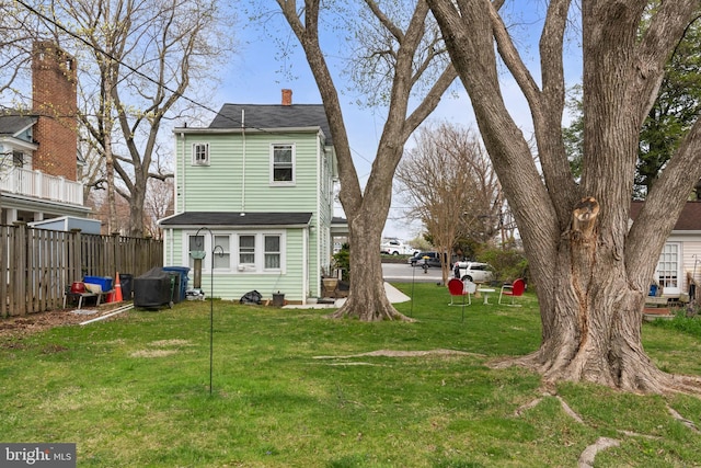 604 6th St, Annapolis, MD 21403 - back of house featuring a chimney, fence, and a lawn