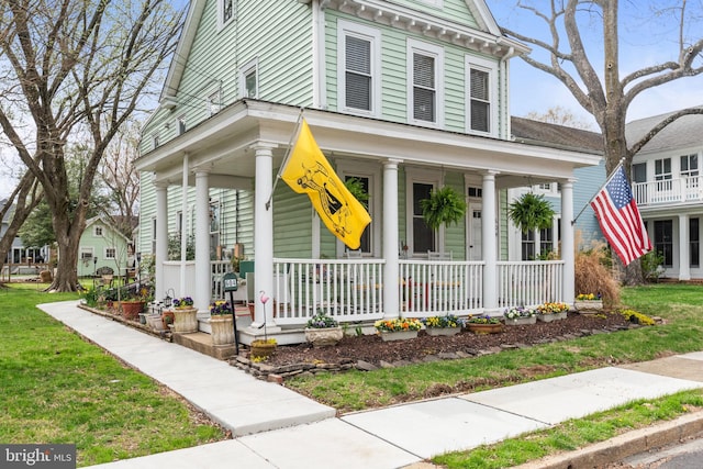 604 6th St, Annapolis, MD 21403 - view of front of house featuring a porch and a front lawn