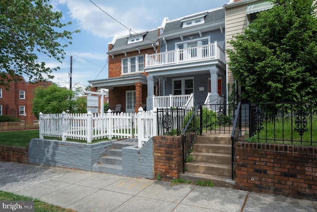 4931 4th St NW, Washington, DC 20011 - victorian home with covered porch, mansard roof, brick siding, and a fenced front yard