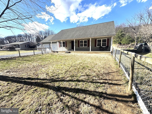 view of front of house featuring a garage, a fenced backyard, a porch, and a front lawn