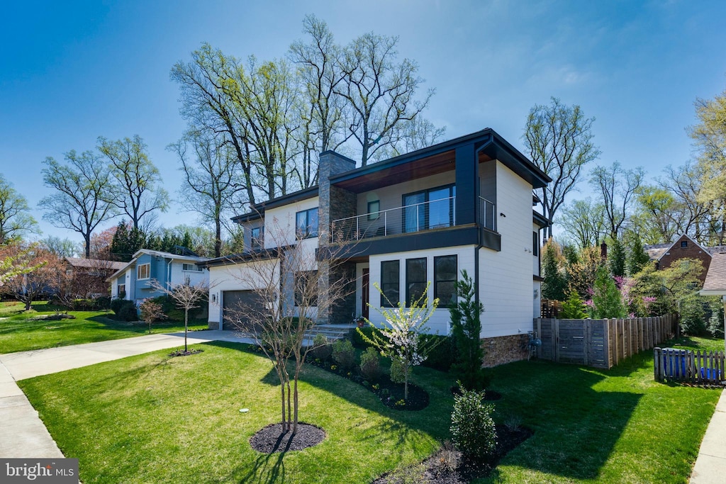 5600 Huntington Pkwy, Bethesda, MD 20814 - modern home with a balcony, driveway, fence, and a front lawn