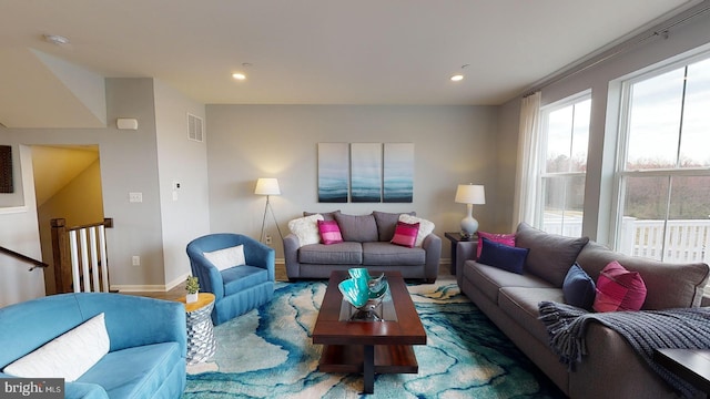 living area with baseboards, visible vents, wood finished floors, and recessed lighting