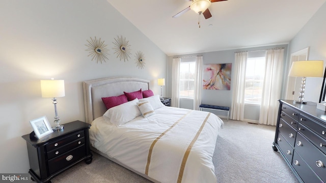 bedroom with light colored carpet, vaulted ceiling, and ceiling fan