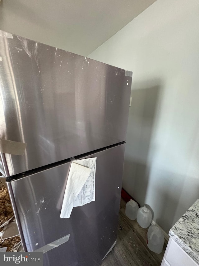 details with wood finished floors and freestanding refrigerator