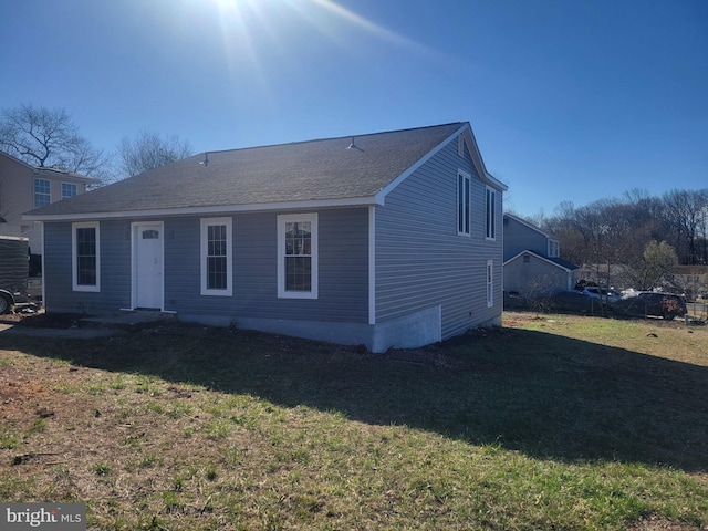 7601 Milligan Ln, Clinton, MD 20735 - rear view of property featuring roof with shingles and a yard