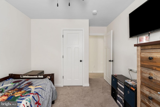 bedroom with baseboards and carpet flooring