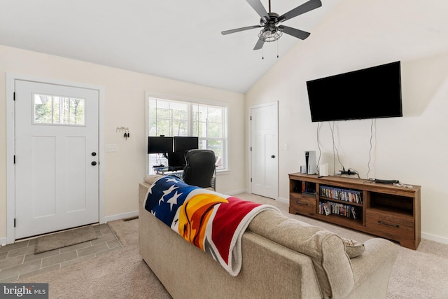 living area with baseboards, a ceiling fan, high vaulted ceiling, and light carpet