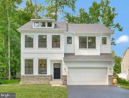 308 Alameda Pkwy, Arnold, MD 21012 - view of front of property with stone siding, driveway, a front lawn, and an attached garage