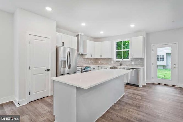 308 Alameda Pkwy, Arnold, MD 21012 - kitchen featuring white cabinetry, wood finished floors, stainless steel appliances, and a center island