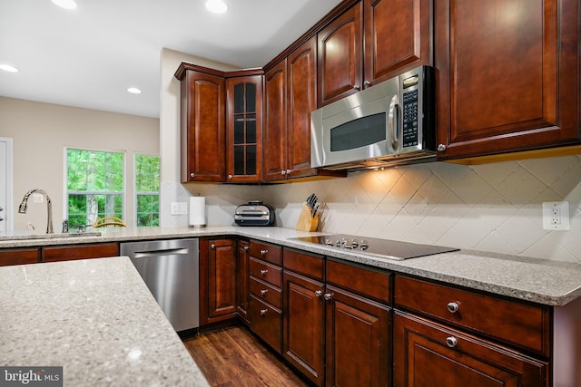 31 Crescent Links Dr, North East, MD 21901 - kitchen featuring a sink, light stone counters, dark wood-style flooring, decorative backsplash, and appliances with stainless steel finishes
