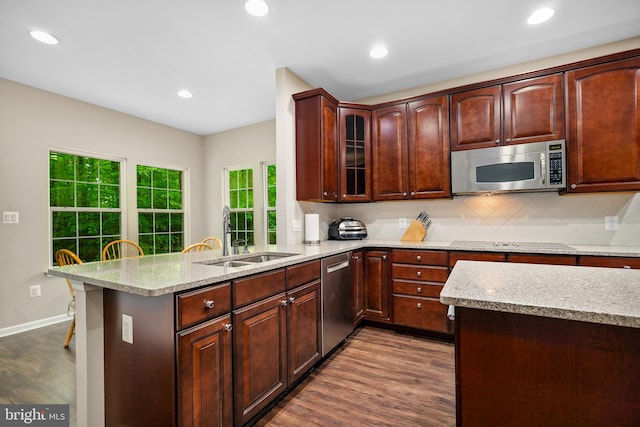 31 Crescent Links Dr, North East, MD 21901 - kitchen featuring dark wood finished floors, a sink, a peninsula, backsplash, and appliances with stainless steel finishes