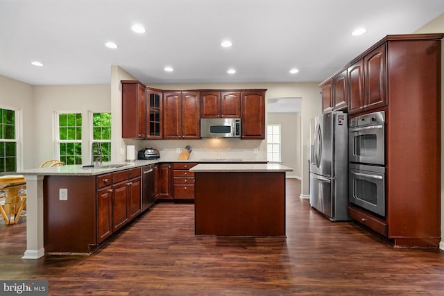 31 Crescent Links Dr, North East, MD 21901 - kitchen with recessed lighting, stainless steel appliances, a peninsula, and dark wood finished floors