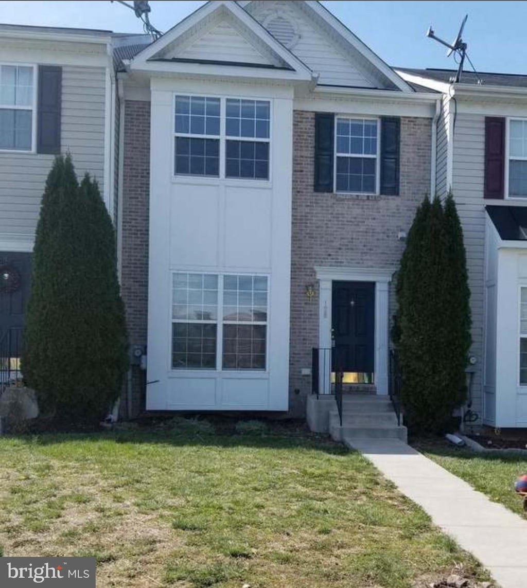 128 Whitman Ln, Inwood, WV 25428 - view of property featuring brick siding and a front yard