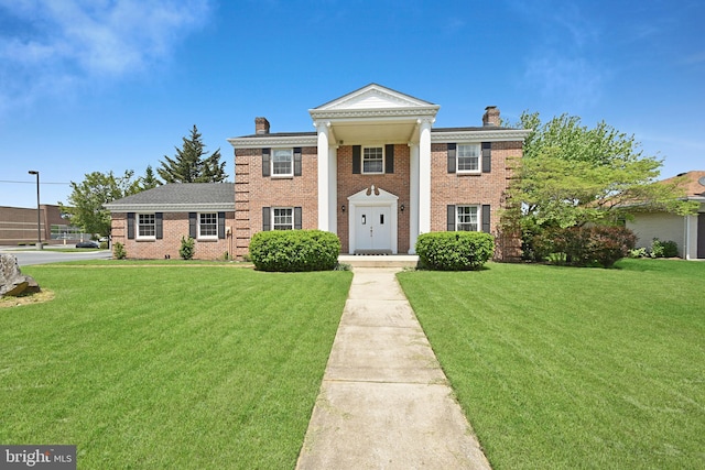 1003 E Cherry St, Palmyra, PA 17078 - greek revival house with brick siding, a front lawn, and a chimney