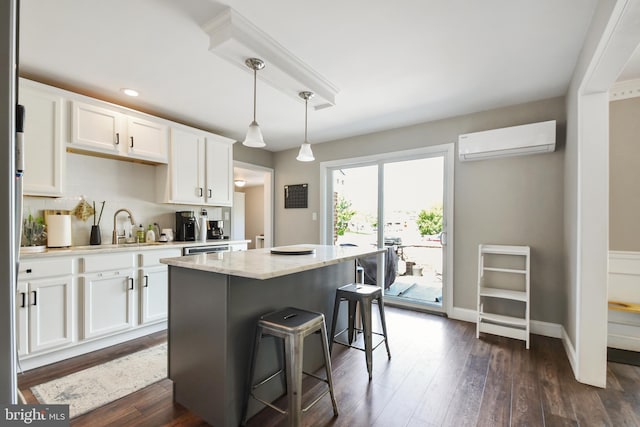 1003 E Cherry St, Palmyra, PA 17078 - kitchen with a wall mounted air conditioner, a sink, white cabinetry, a kitchen island, and a breakfast bar area