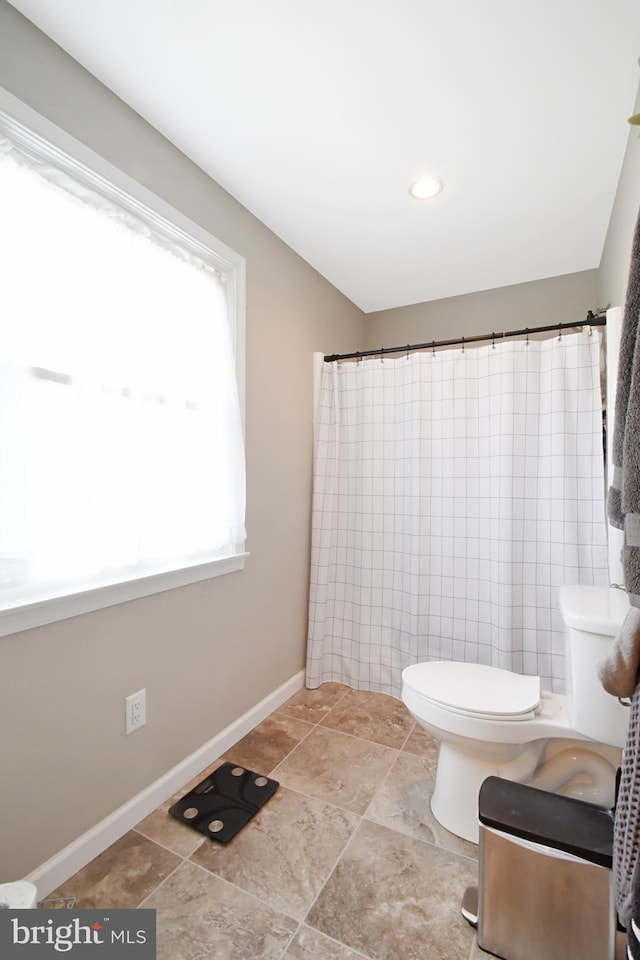 1003 E Cherry St, Palmyra, PA 17078 - bathroom featuring a shower with shower curtain, baseboards, and toilet