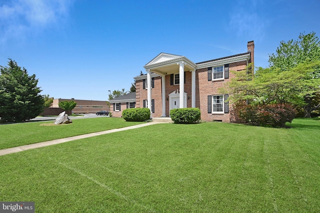 1003 E Cherry St, Palmyra, PA 17078 - greek revival inspired property with a chimney, a front yard, and brick siding