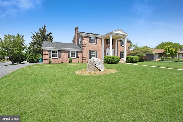 1003 E Cherry St, Palmyra, PA 17078 - neoclassical home with brick siding, a front lawn, and a chimney