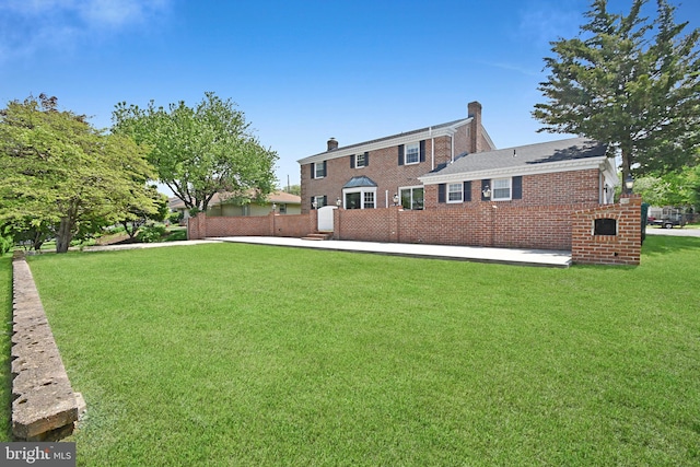 1003 E Cherry St, Palmyra, PA 17078 - rear view of house featuring brick siding and a lawn