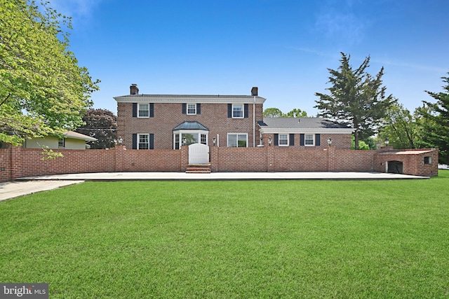 1003 E Cherry St, Palmyra, PA 17078 - colonial inspired home with a chimney, a front lawn, and brick siding