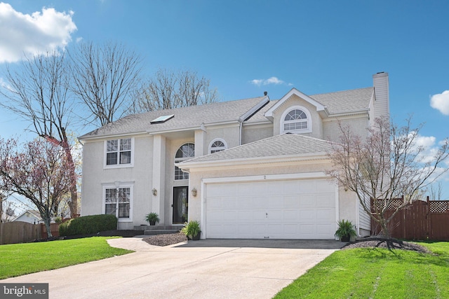 view of front of property featuring a front yard, an attached garage, fence, stucco siding, and driveway