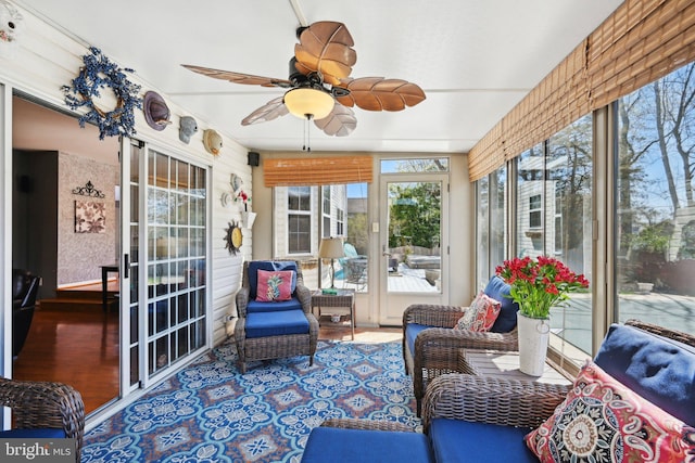 sunroom / solarium featuring wood finished floors and a ceiling fan