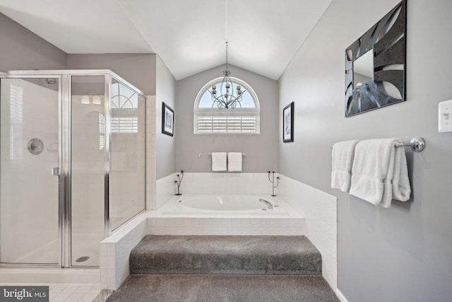 bathroom with a shower stall, a bath, a chandelier, and vaulted ceiling