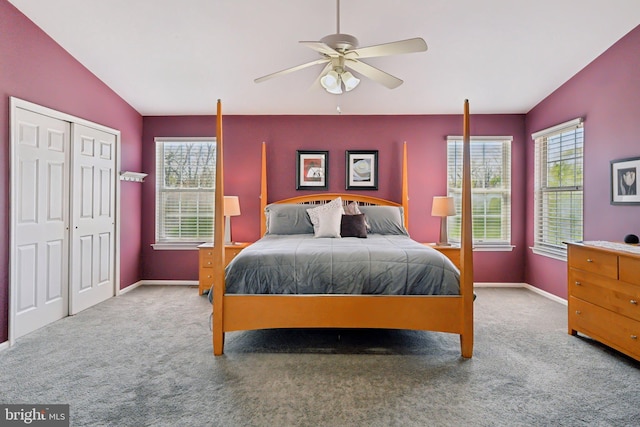 bedroom featuring carpet, multiple windows, and baseboards