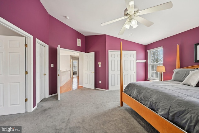 carpeted bedroom featuring visible vents, ceiling fan, baseboards, and lofted ceiling