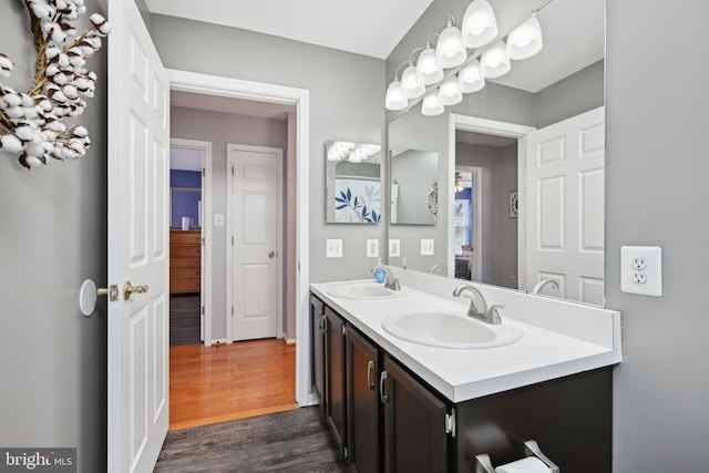 bathroom featuring double vanity, a sink, and wood finished floors