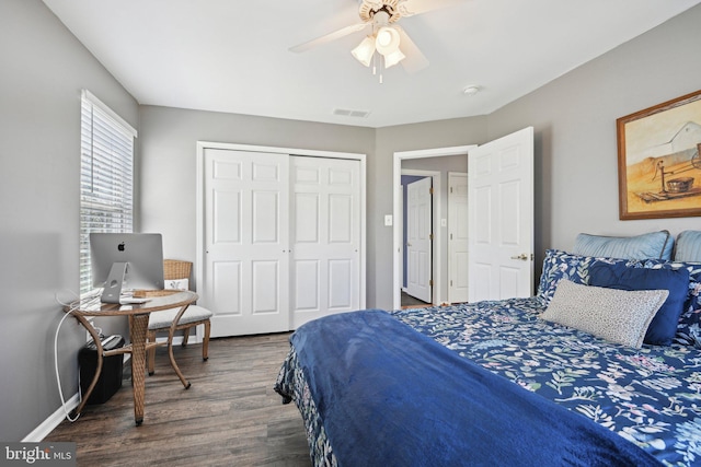 bedroom with baseboards, a closet, a ceiling fan, visible vents, and wood finished floors