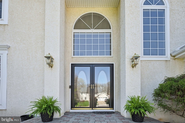doorway to property with stucco siding