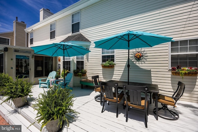 wooden terrace featuring outdoor dining space