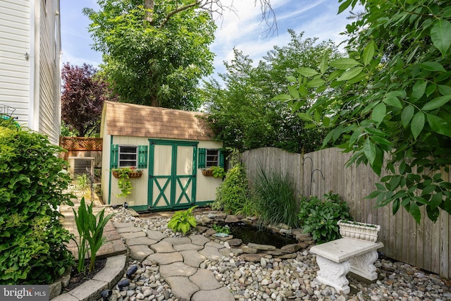 view of shed with fence