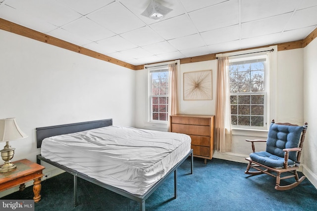 bedroom with baseboards and dark colored carpet