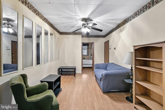 living area featuring wood finished floors and a ceiling fan