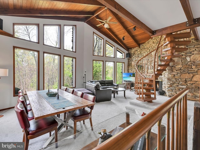 carpeted dining space featuring high vaulted ceiling, wood ceiling, beam ceiling, and a wealth of natural light