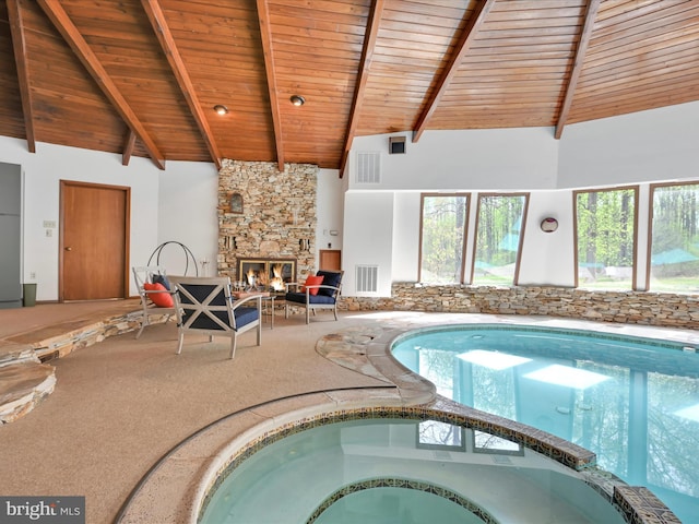 view of pool with a pool with connected hot tub and a fireplace