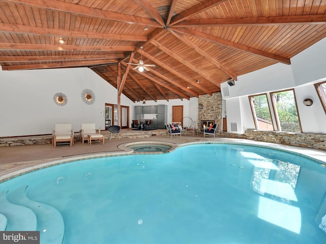 view of swimming pool with a ceiling fan and a pool with connected hot tub