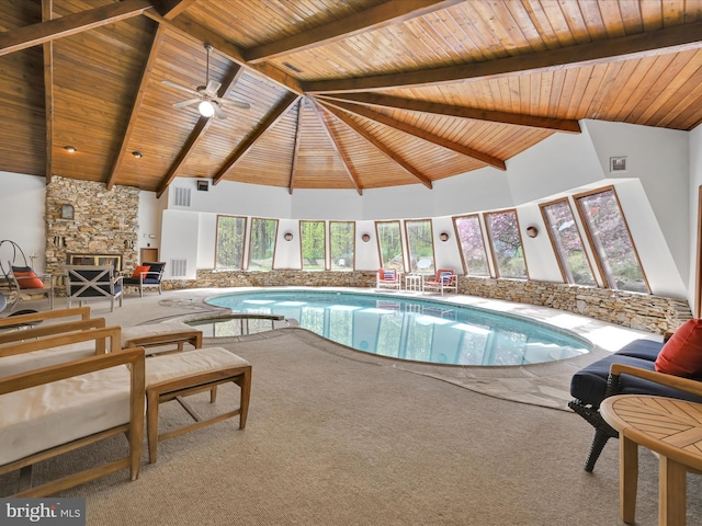 pool with a ceiling fan and a stone fireplace